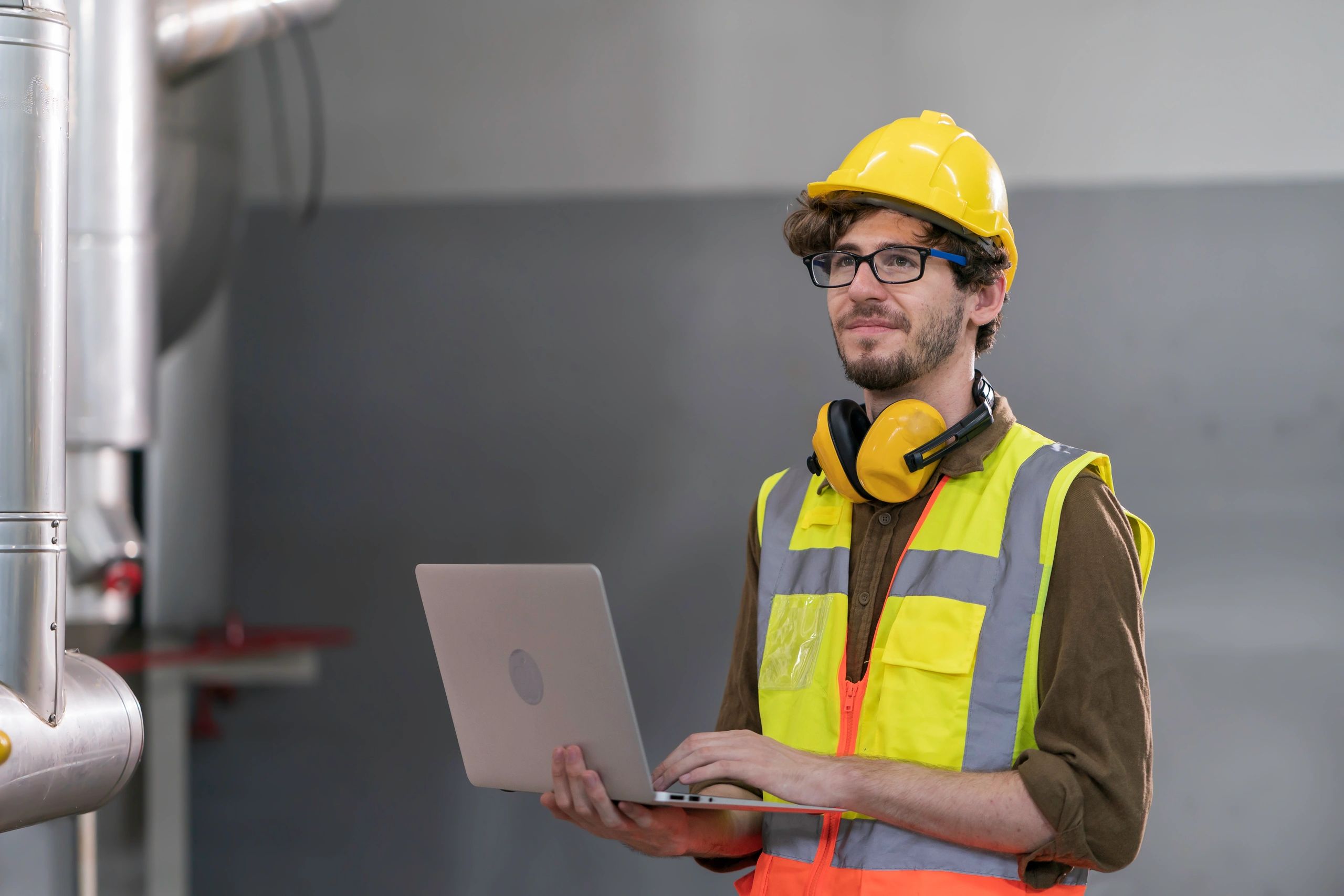 HVAC engineer checking equipment in an industrial boiler room