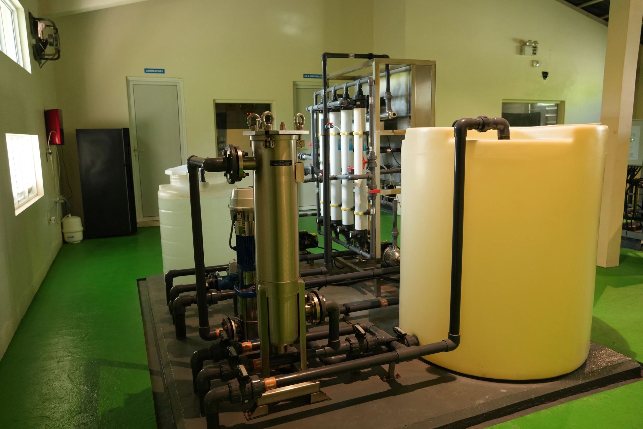 Industrial water processing system with tanks, filtration units, and piping